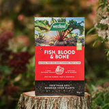 Westland Fish, Blood & Bone fertilizer packaging on a wooden stump with a natural background